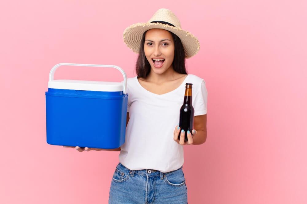 A lady holding a chilled beer