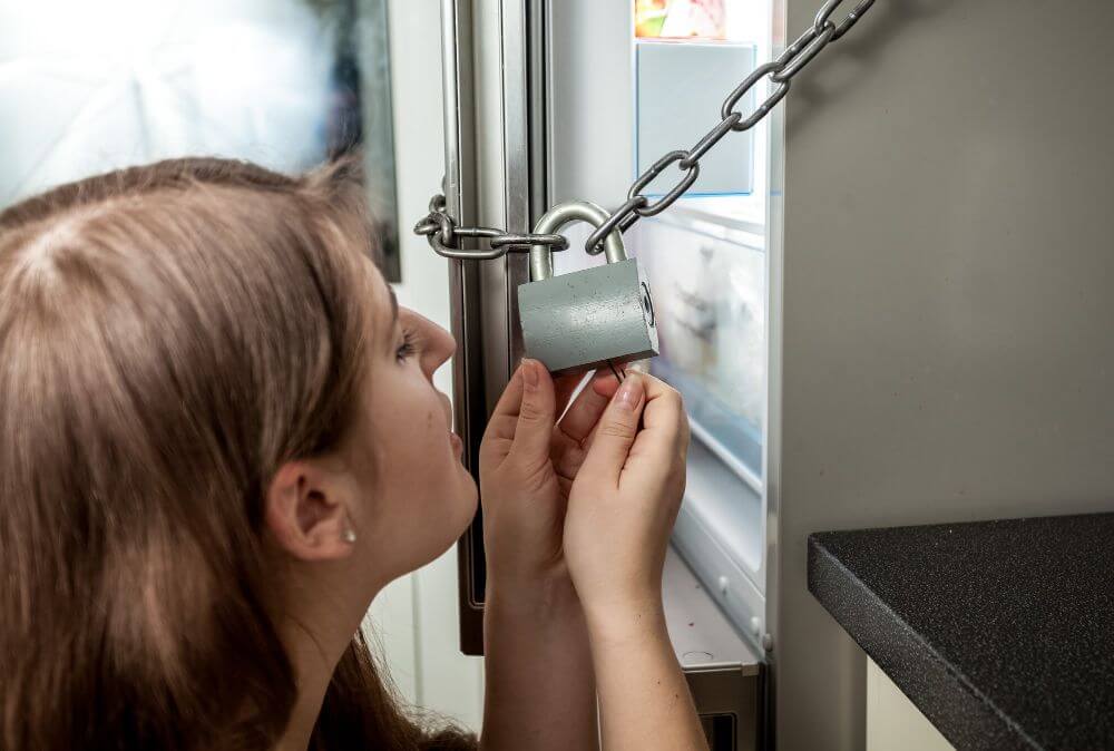 Woman trying to unlock a freezer