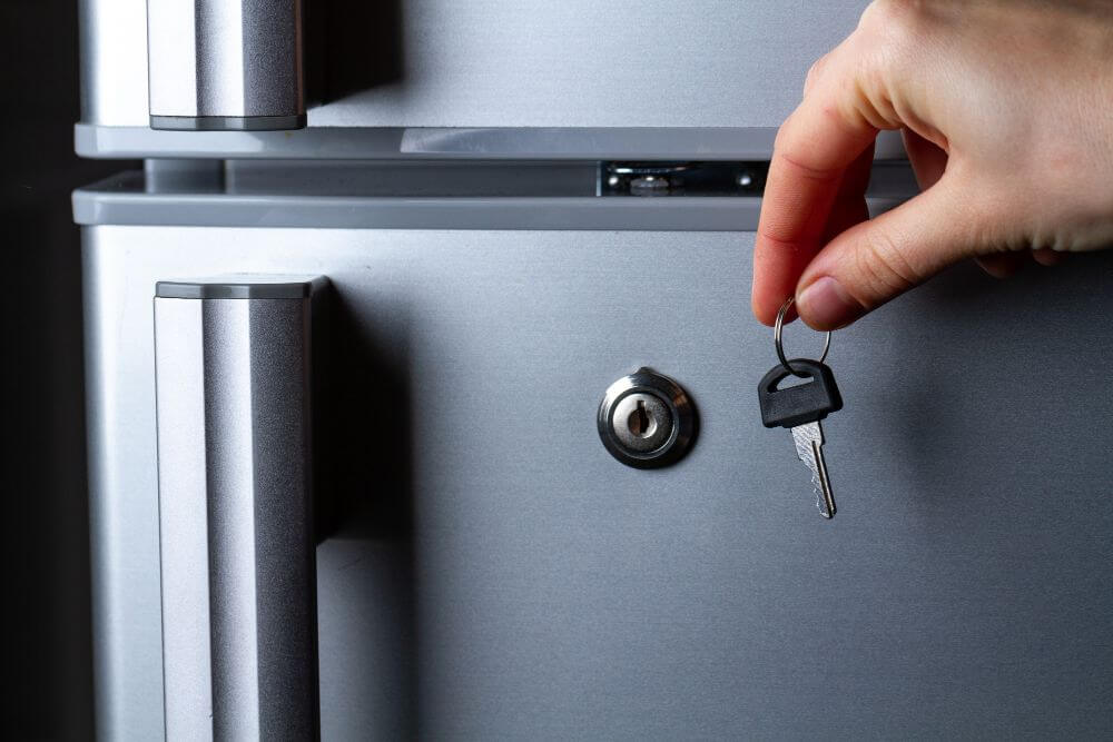 A person showing a key for refrigerator lock