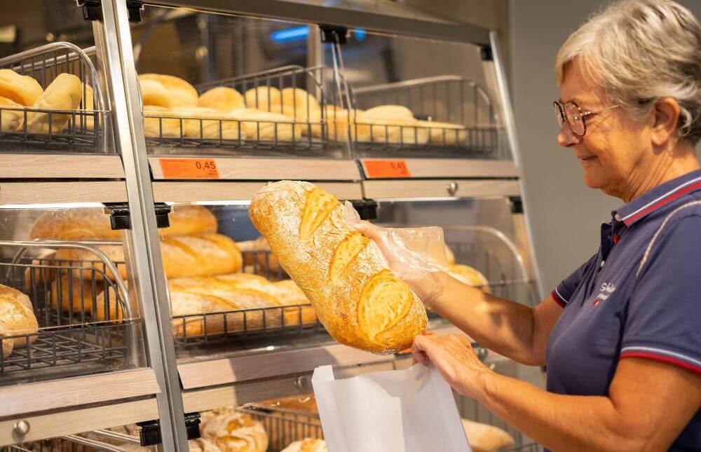 A woman buying cheese bread