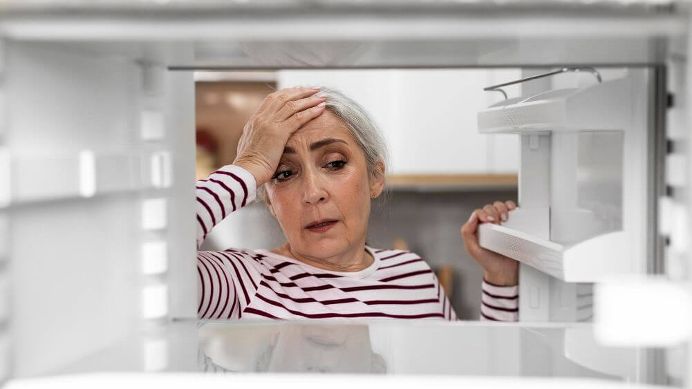 Aged woman having hard time while Choosing a Solar-Powered Refrigerator